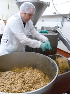 Field Roast employee mixes ingredients to make vegan sausages.