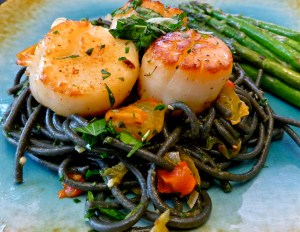 Black squid ink pasta is the perfect color contrast to the seared scallops. Photo by Christine Willmsen